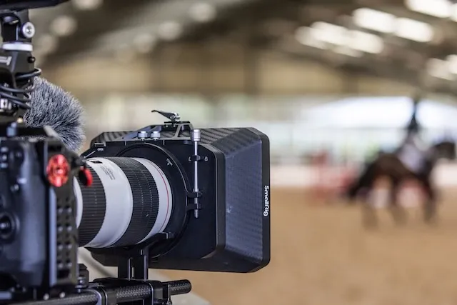 A video camera filming a horse
