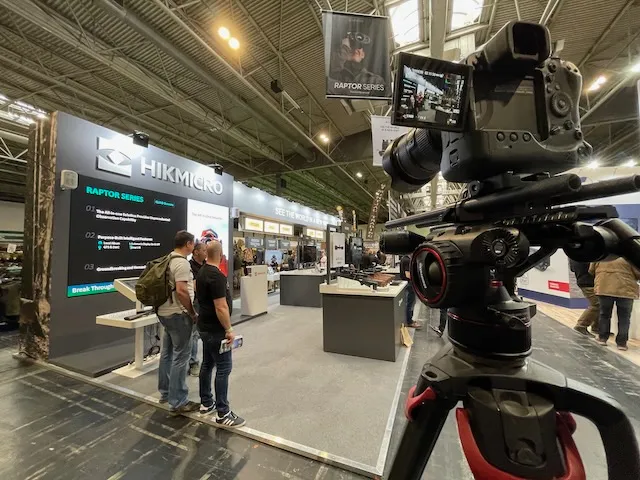 A video camera filming a trade stand
