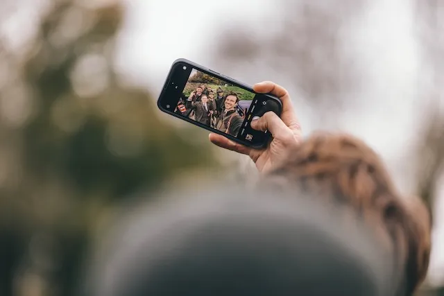 a man taking a selfie of his friends